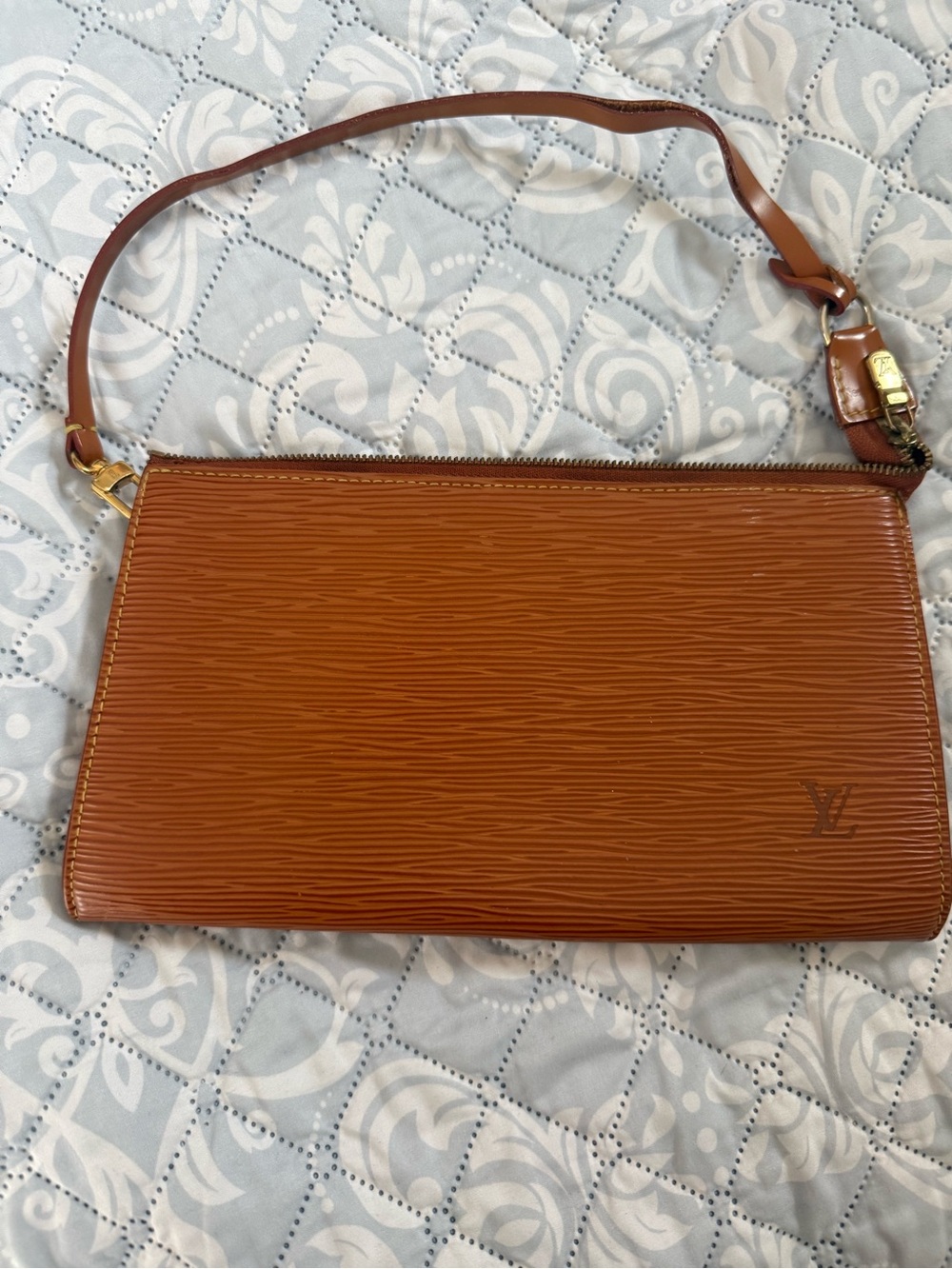 Louis Vuitton Tan Epi Leather Zip Wristlet strap is separating slightly